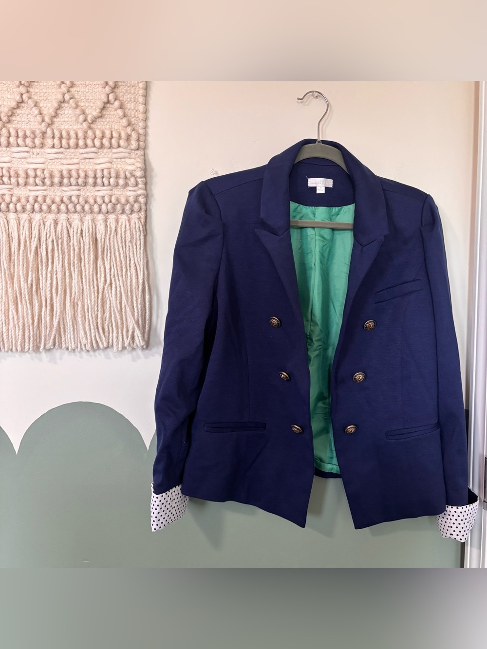 Navy blue blazer with white polka dot cuffs